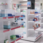 Empty drugstore with bottles and packages full with medicaments, retail shop shelves with pharmaceutical products. Pharmacy space filled with medical drugs and pills, vitamins boxes.