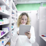 Female pharmacist working in drug store.